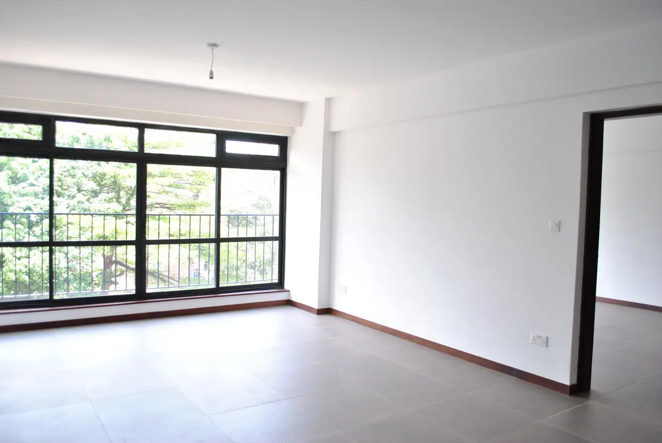 Spacious living room with large windows and balcony access