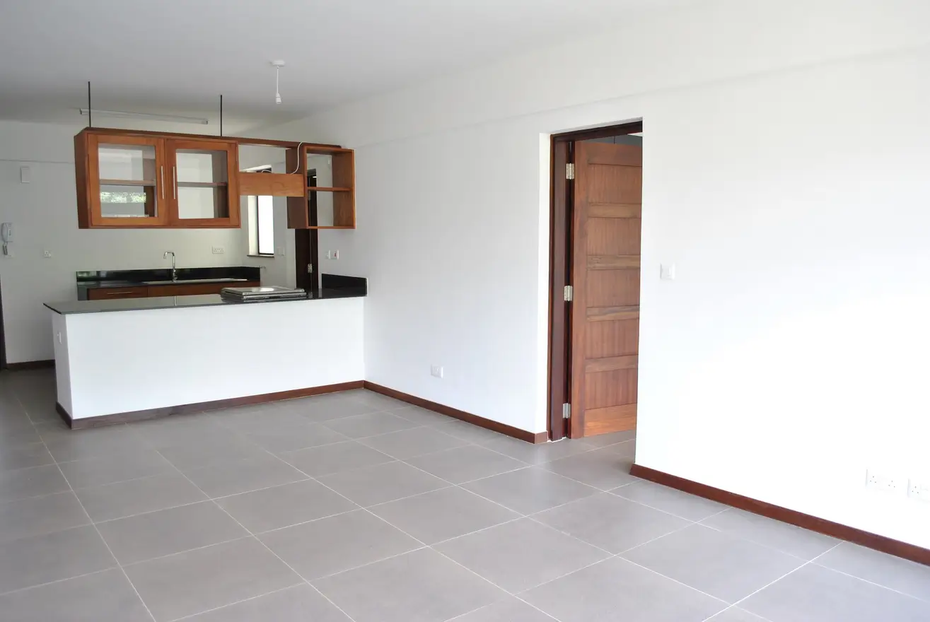 Open-plan kitchen with white counter and wooden cabinets