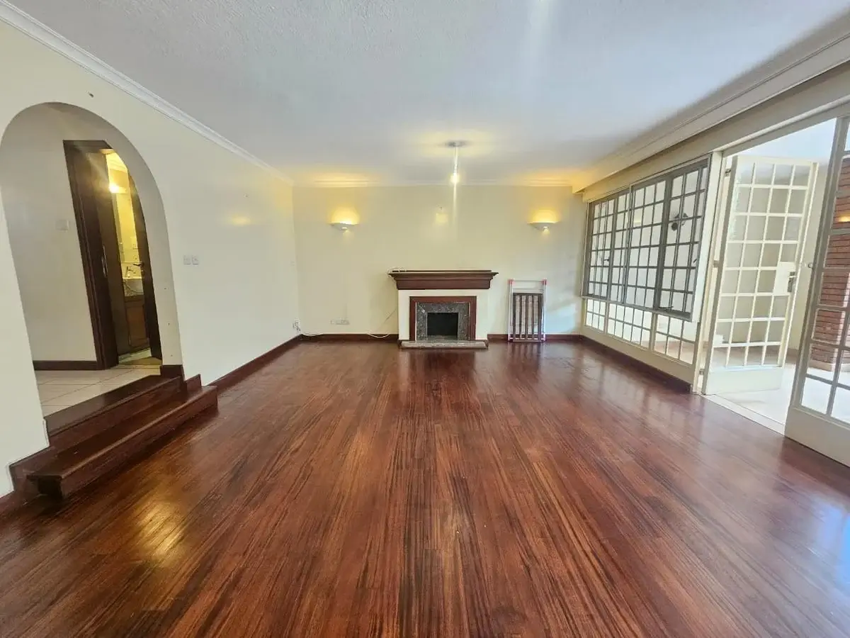 Spacious living room with wooden floors and fireplace