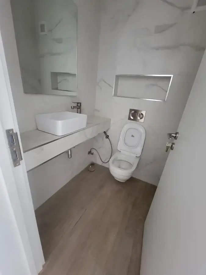 Modern bathroom with vessel sink and toilet