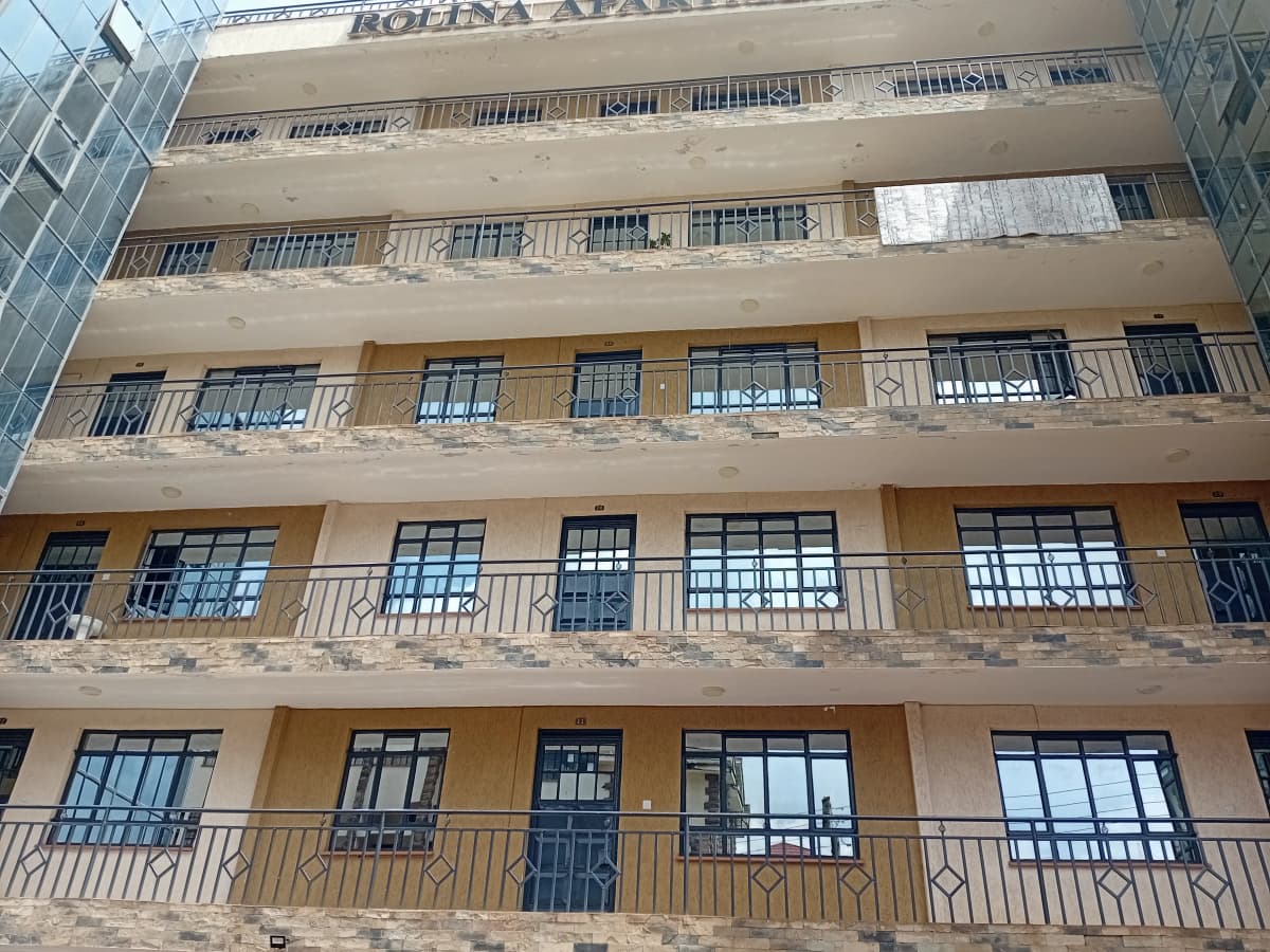 Multi-story residential building facade with balconies and windows