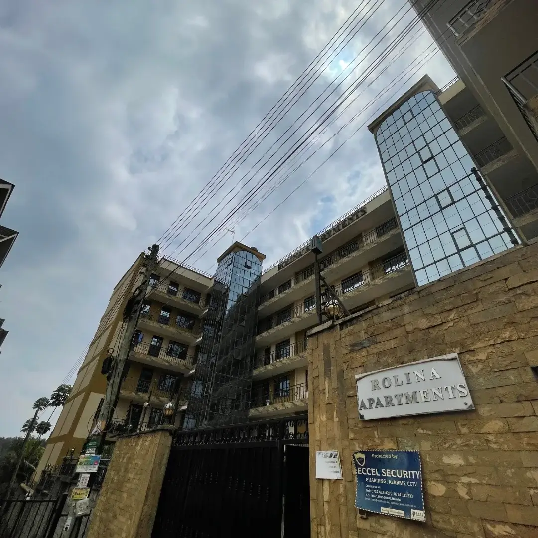 Multi-story residential building facade with stone entrance