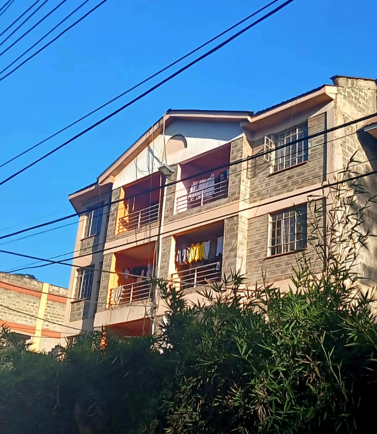 Multi-story residential building facade with balconies and metal railings
