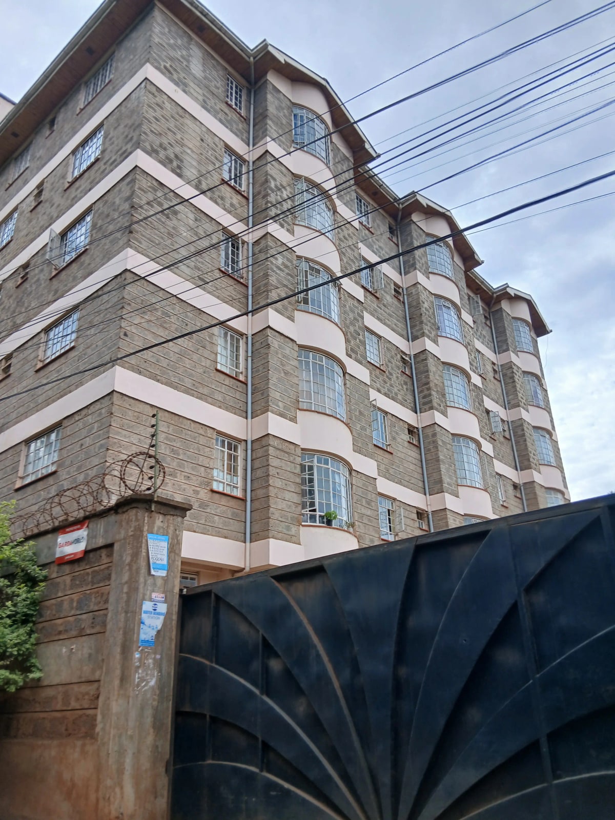 Multi-story residential building facade with stone cladding