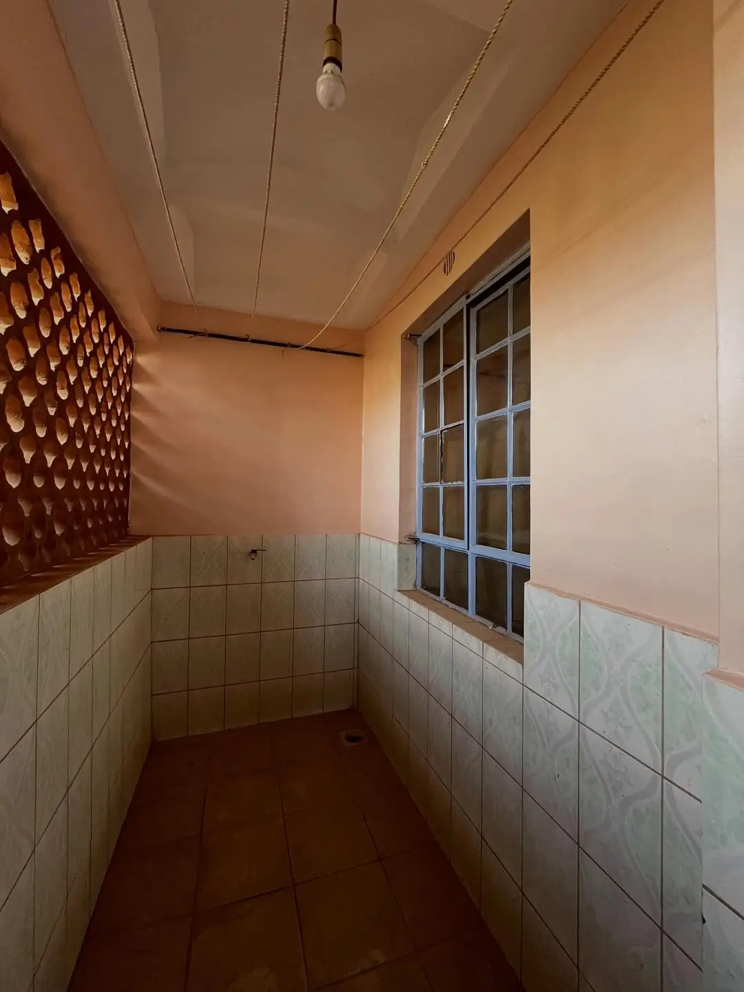 Utility room with tile walls and decorative brick feature