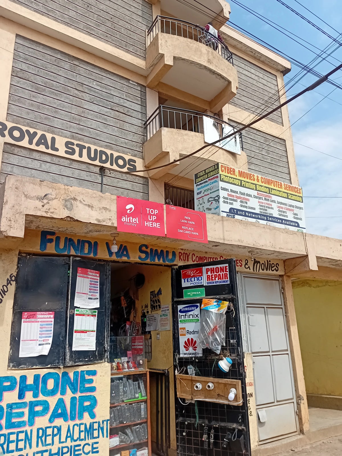 Multi-story residential building facade with ground floor commercial storefronts