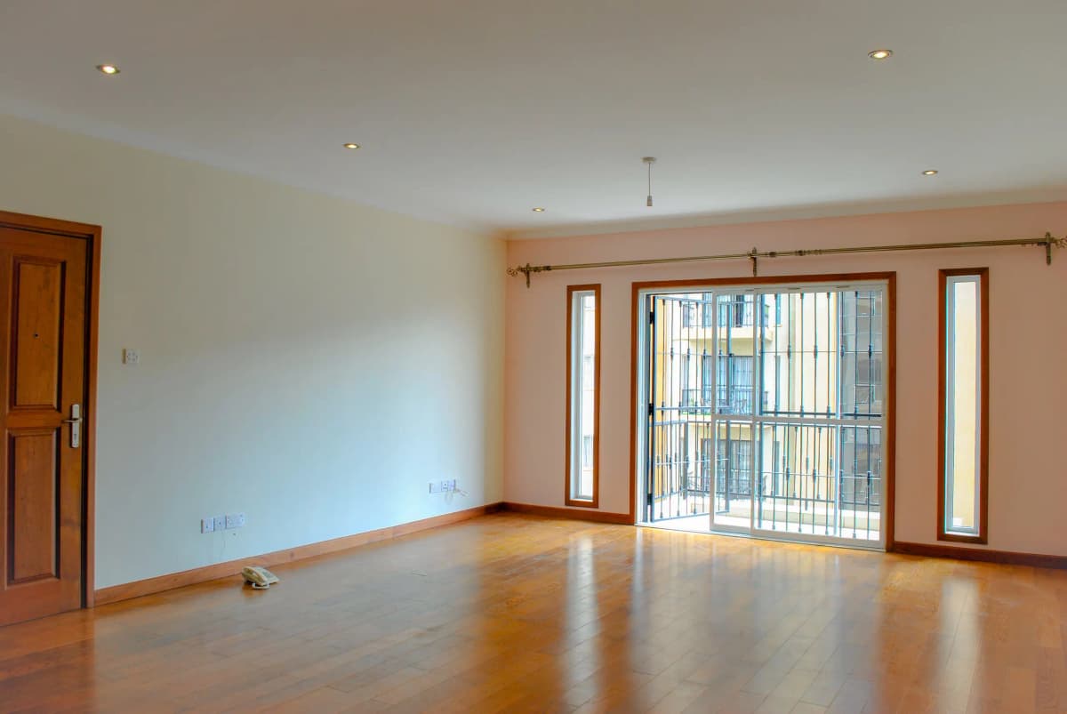 Spacious living room with wooden floors and large windows