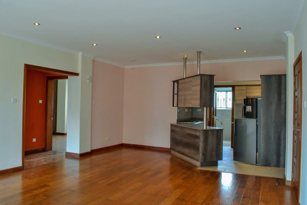 Open-plan living area with kitchen island and stainless steel appliances