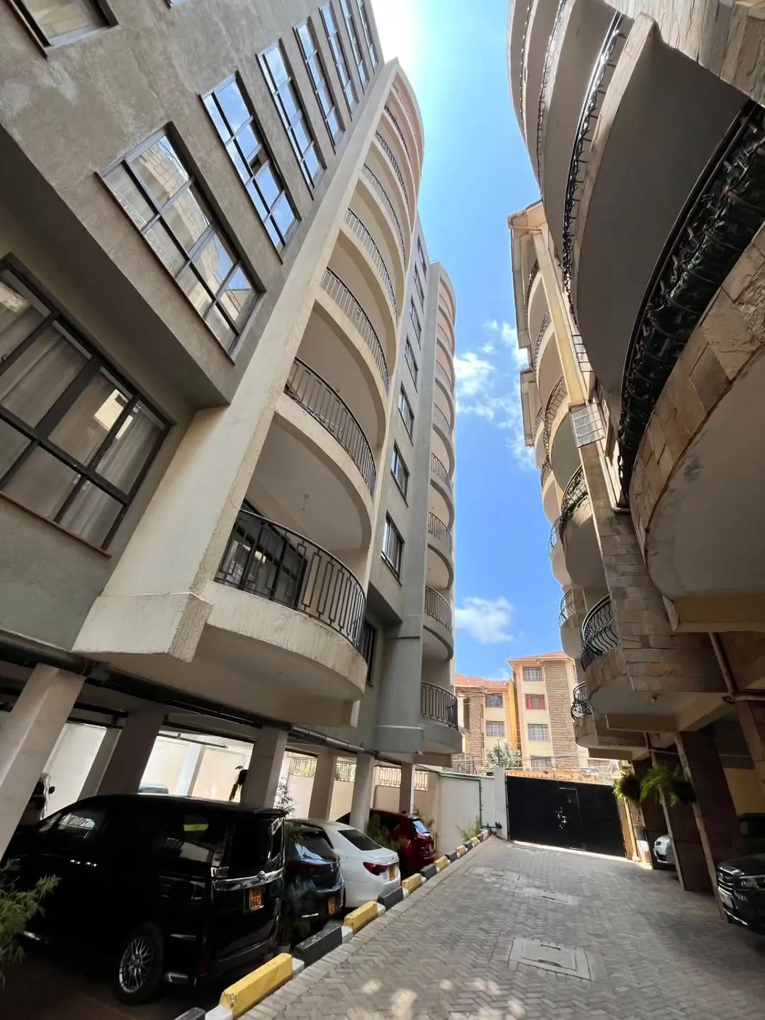 Modern apartment building facade with ground-level parking area