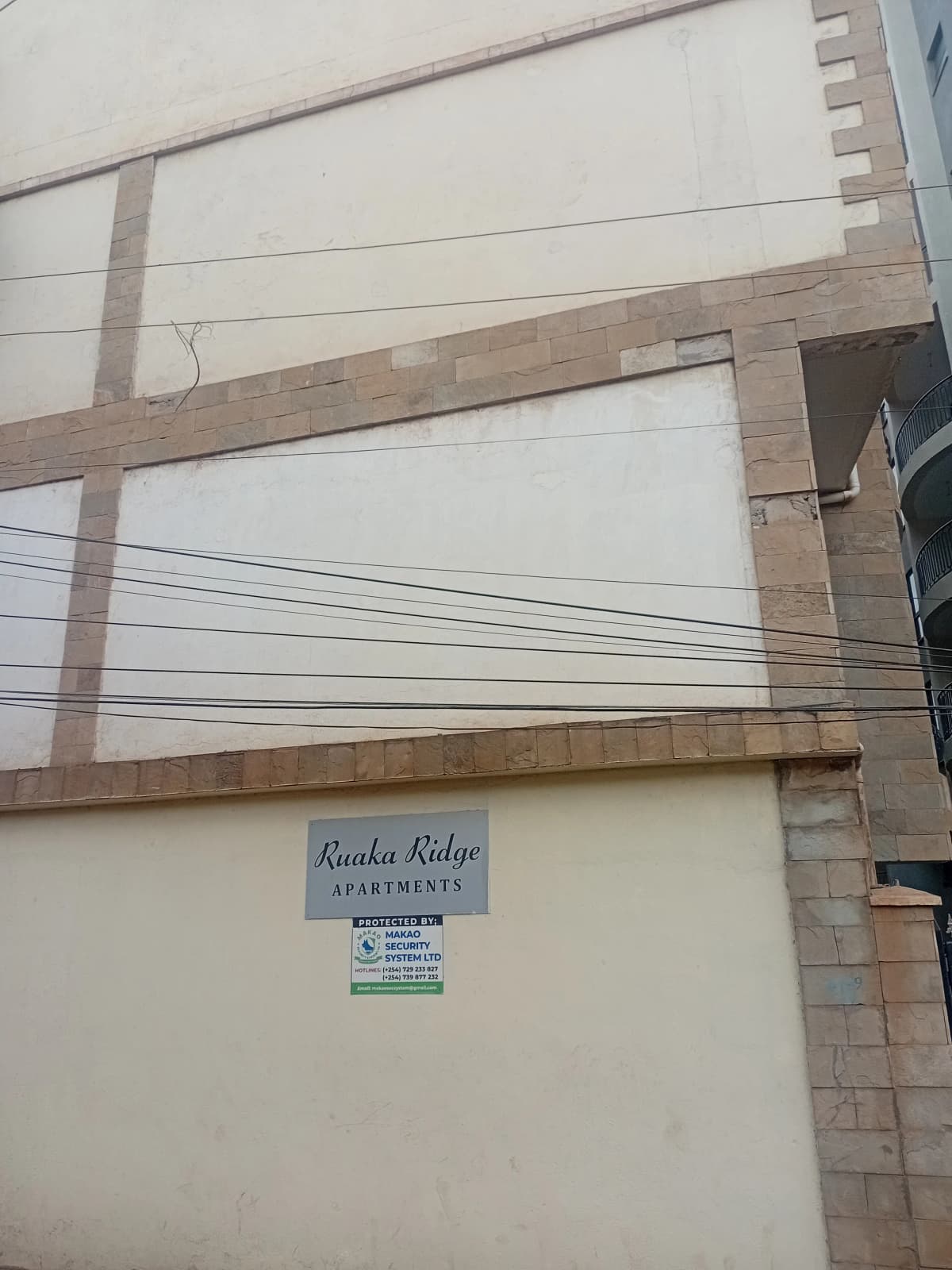 Building facade with signage and power lines visible
