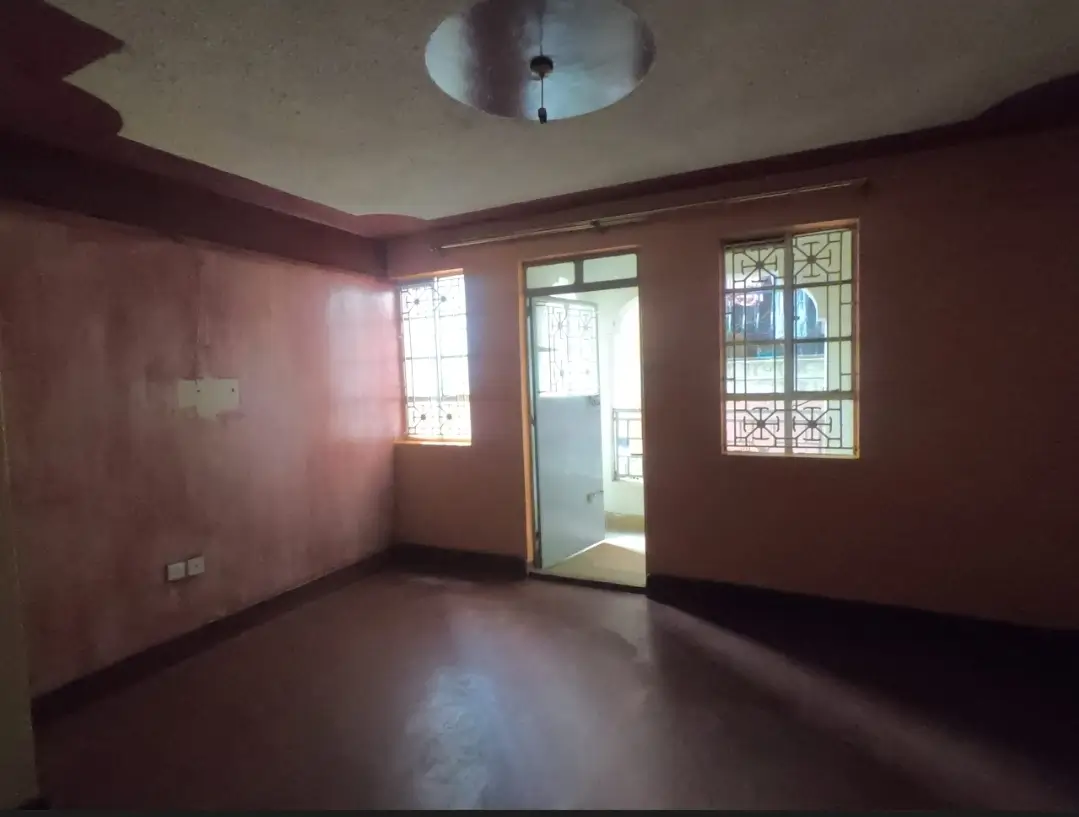 Empty living room with burgundy walls and natural light
