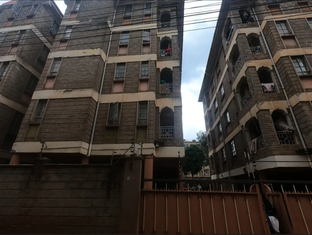 Multi-story apartment buildings with metal gate entrance