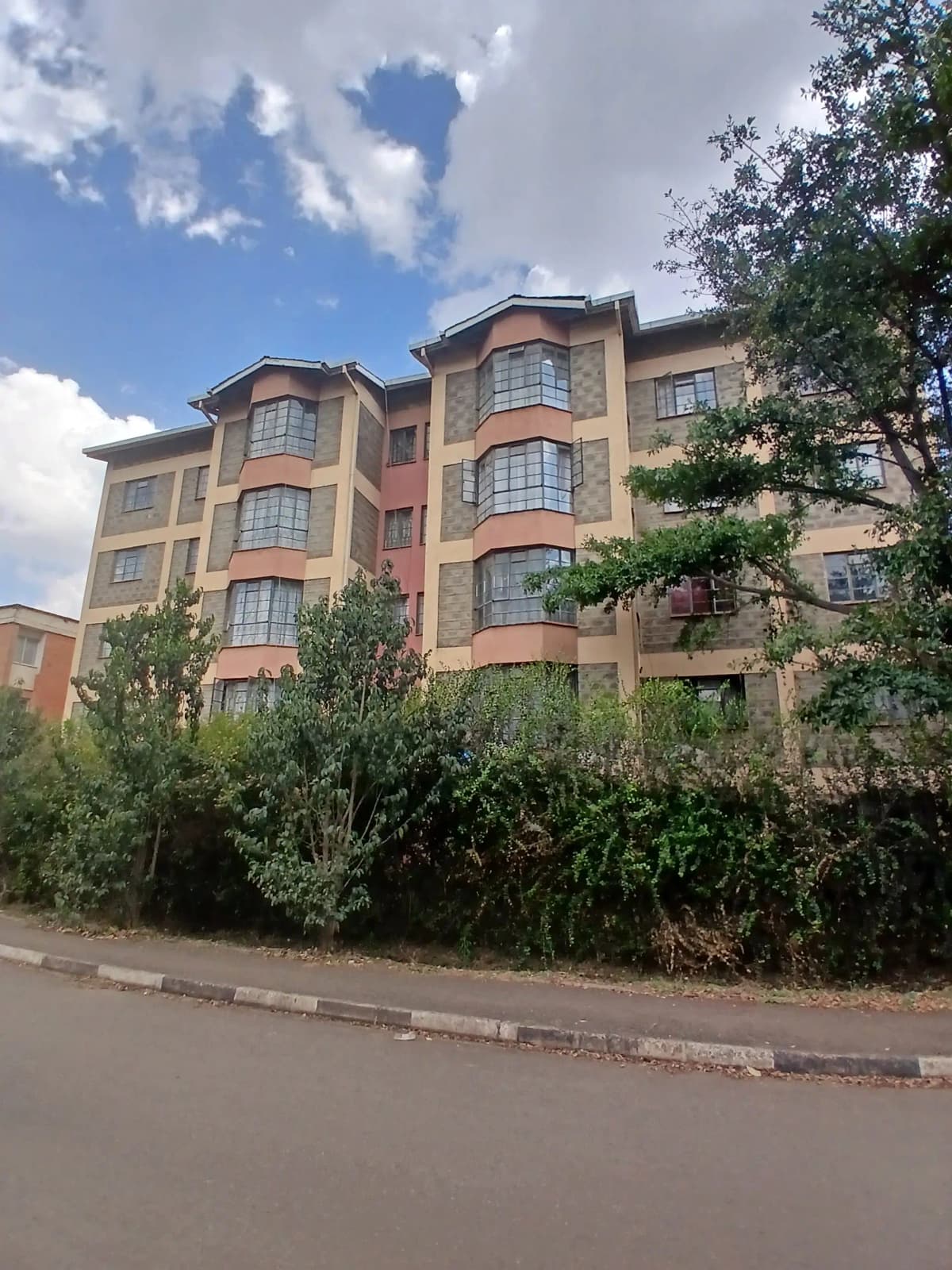 Multi-story residential apartment building with landscaped frontage
