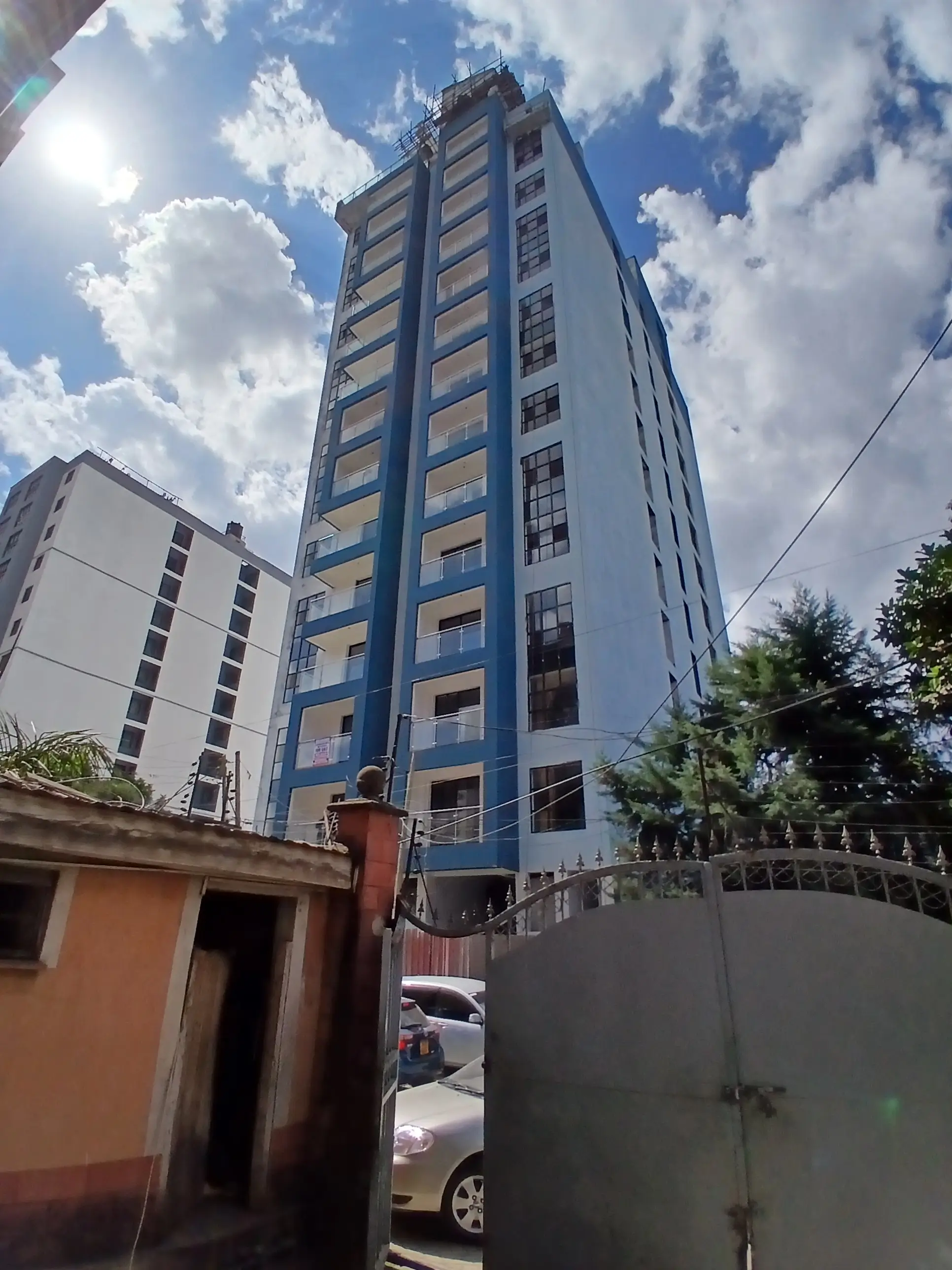 Multi-story residential apartment building with blue facade
