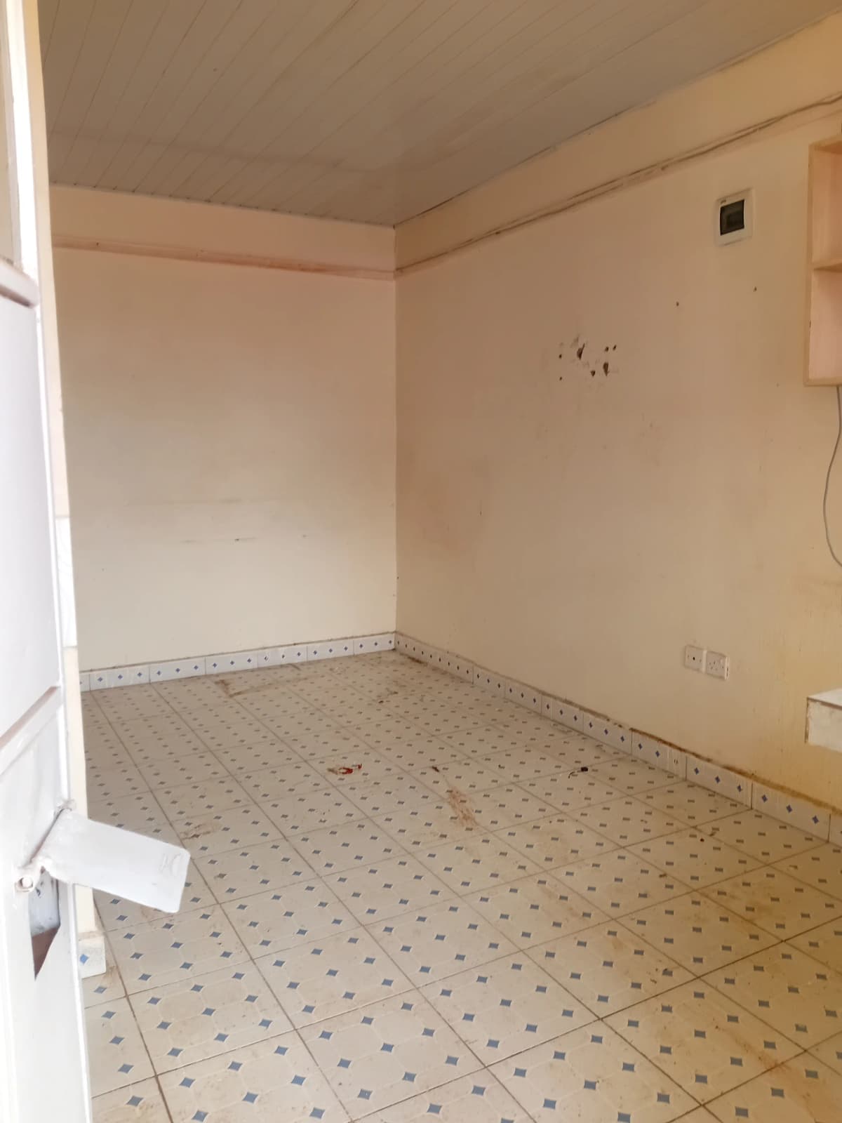 Empty kitchen with tiled floor and basic fixtures