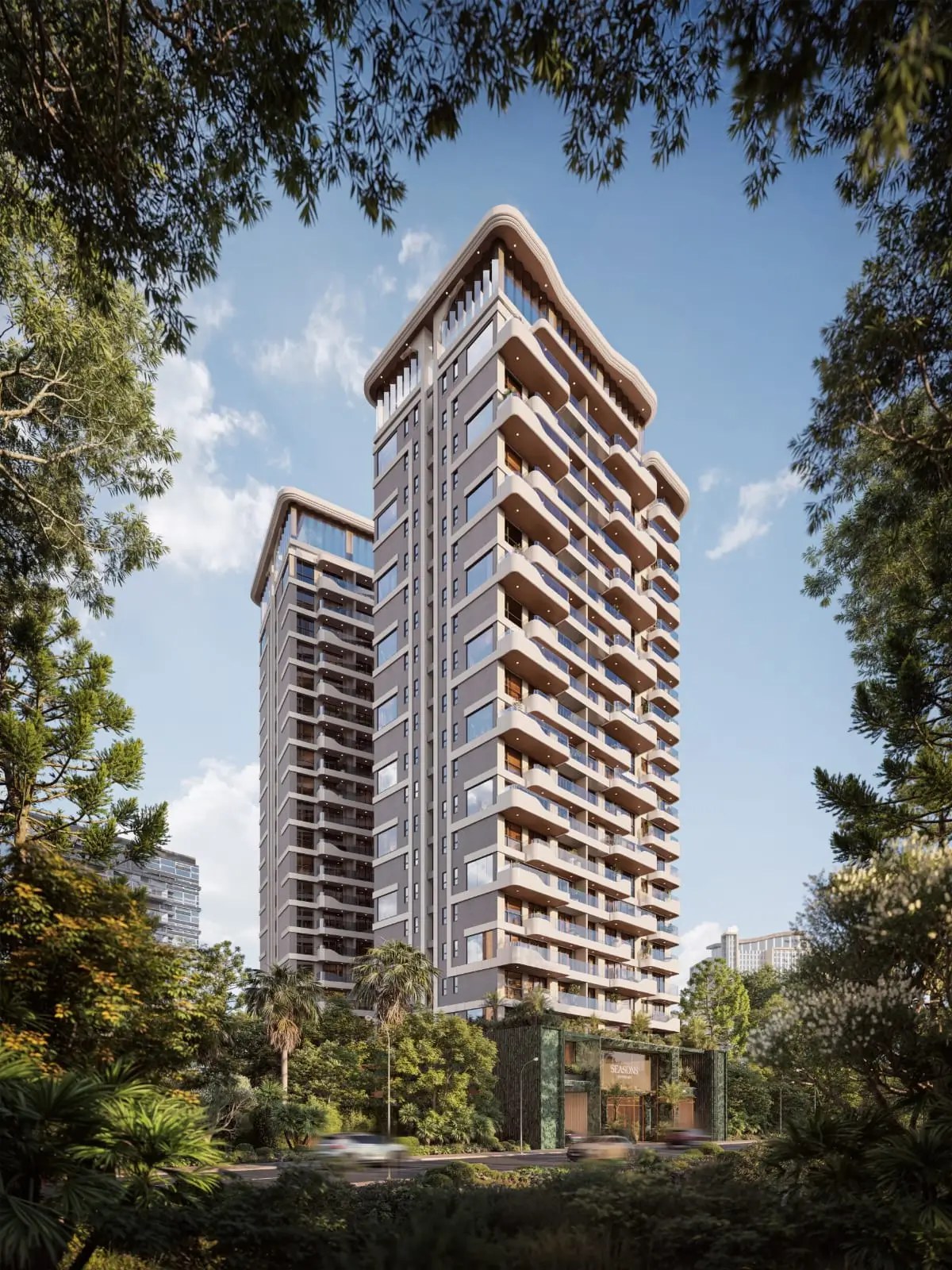 Tall modern high-rise tower surrounded by lush tropical trees