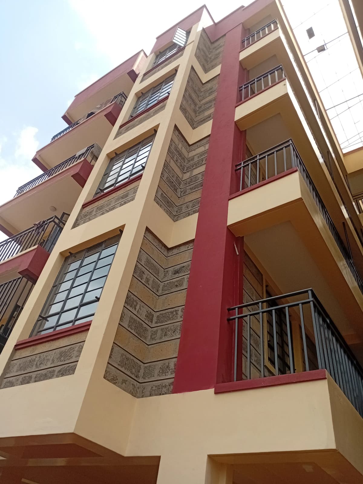 Multi-story residential building facade with balconies and modern design