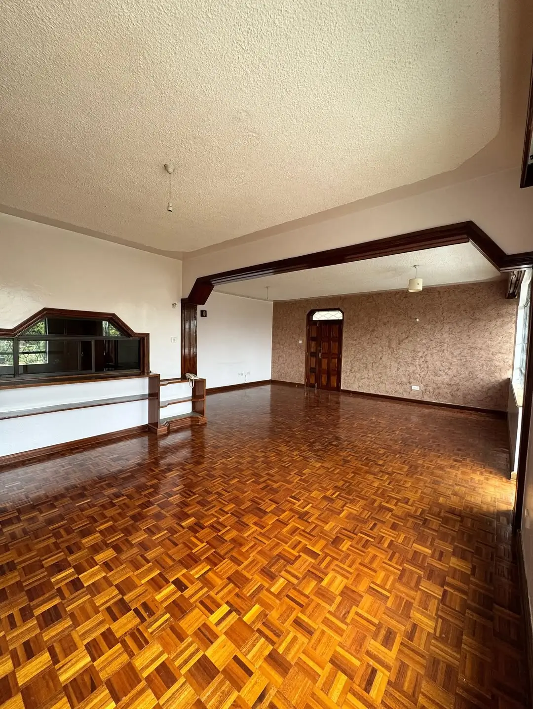 Spacious open-plan living area with herringbone parquet flooring