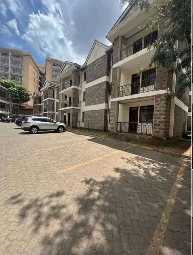 Modern residential building with paved compound and parking bay