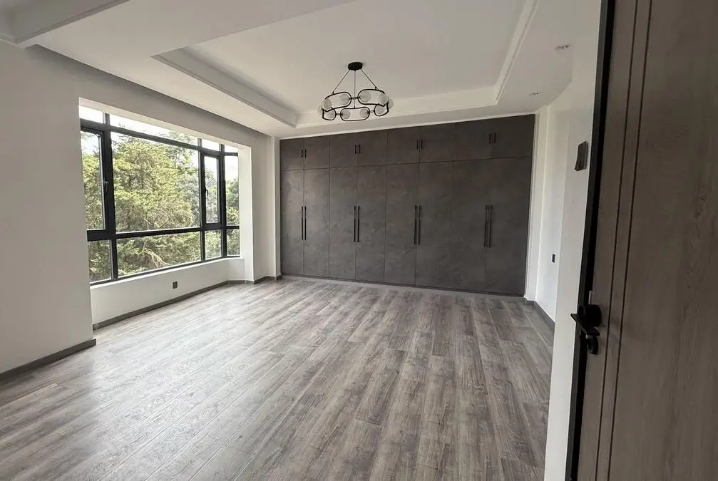Master bedroom with built-in wardrobes and natural light