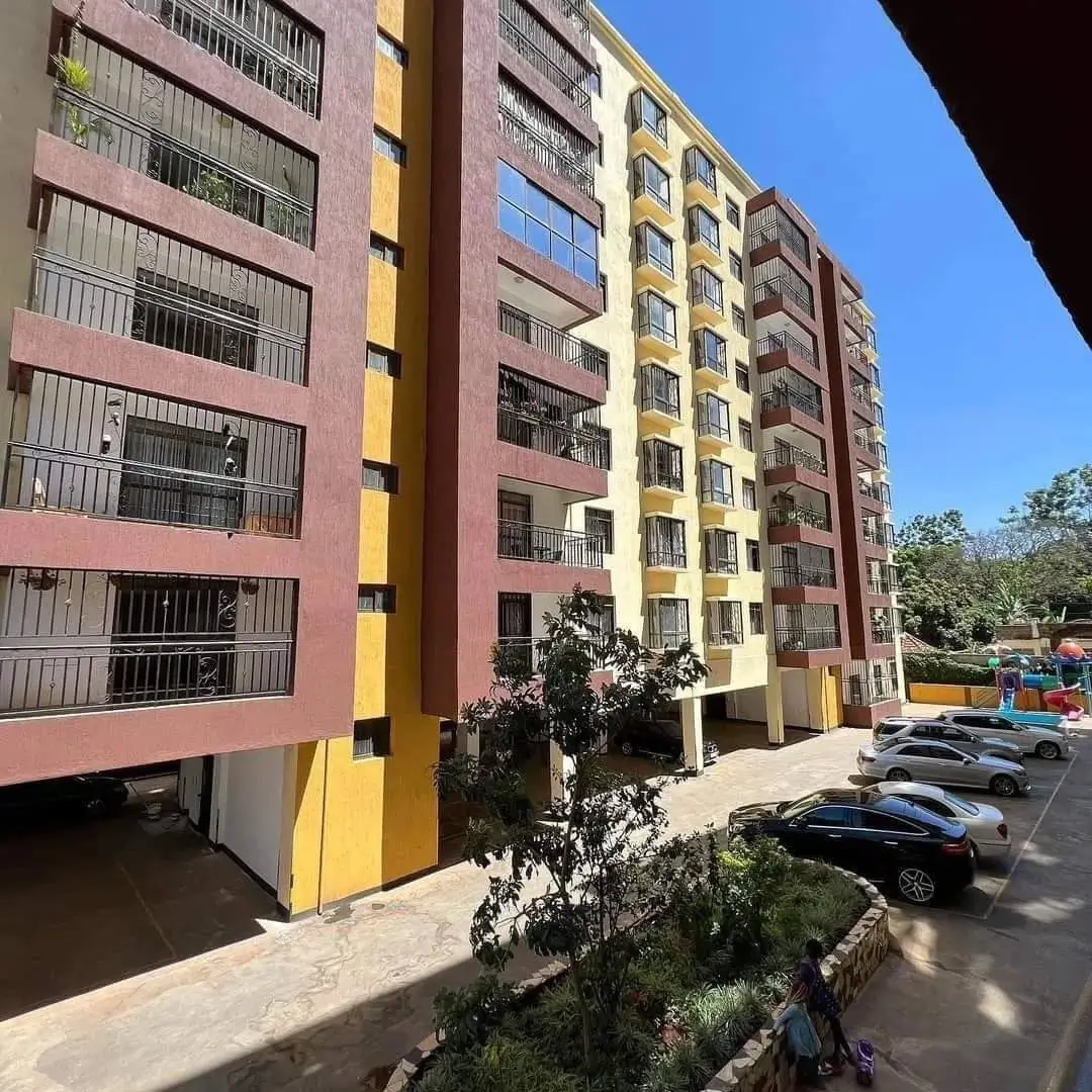 Multi-story residential building with colorful facade and parking