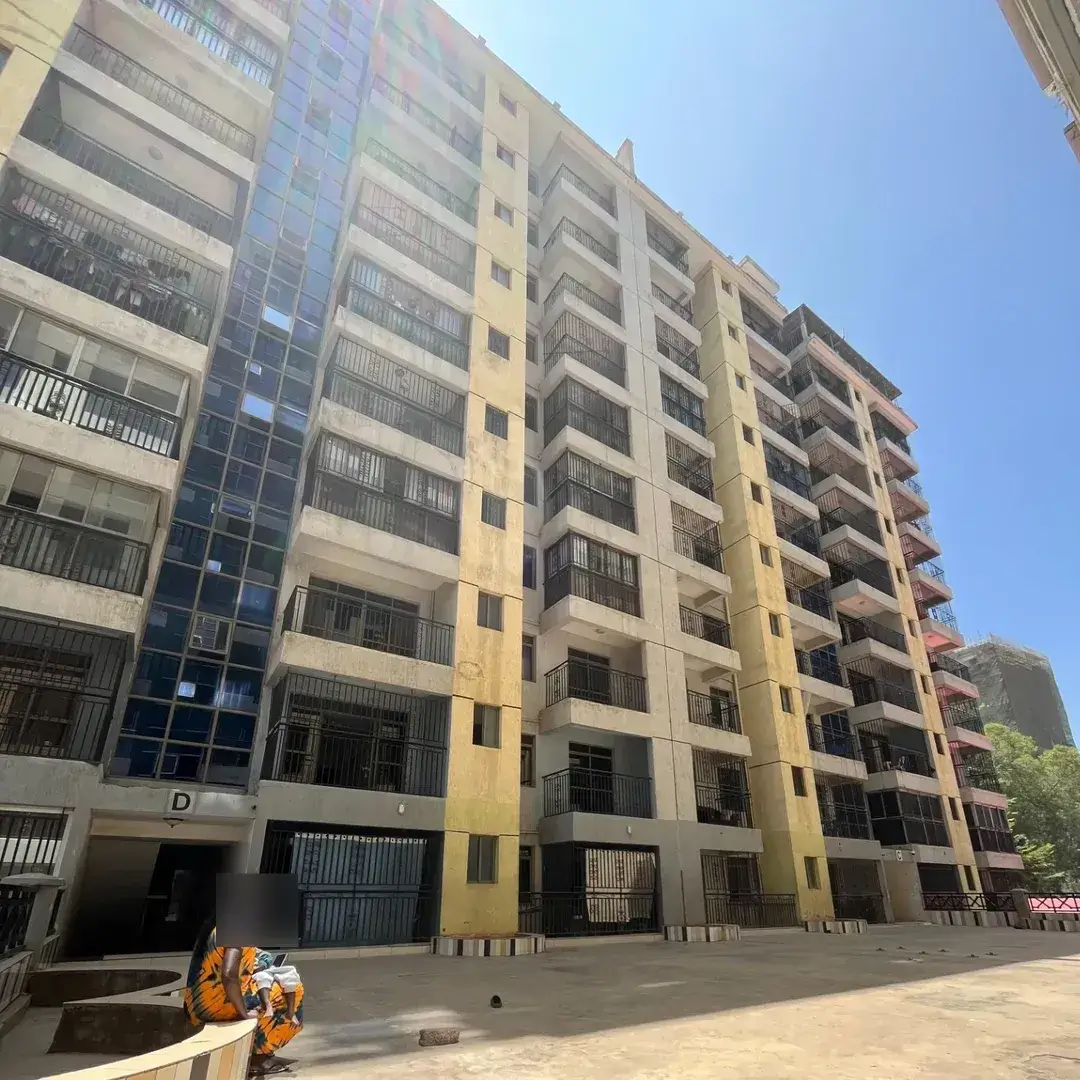 Multi-story residential building facade with balconies and parking