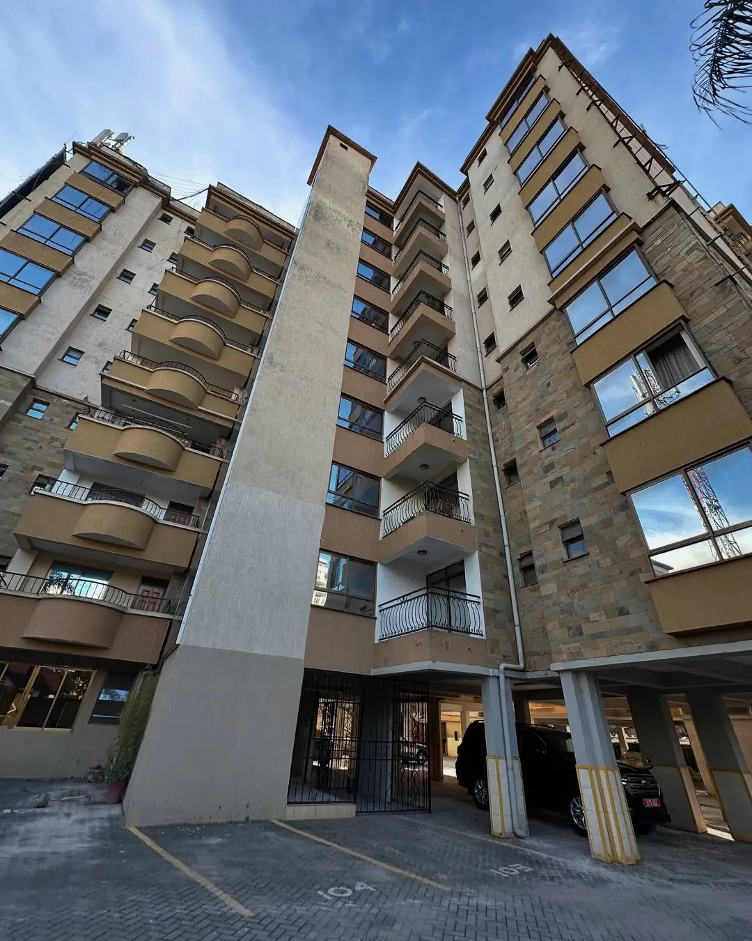 Multi-story residential building facade with ground-floor retail