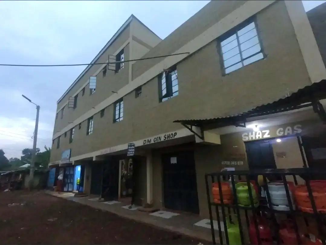 Multi-story residential building with street-level commercial shops