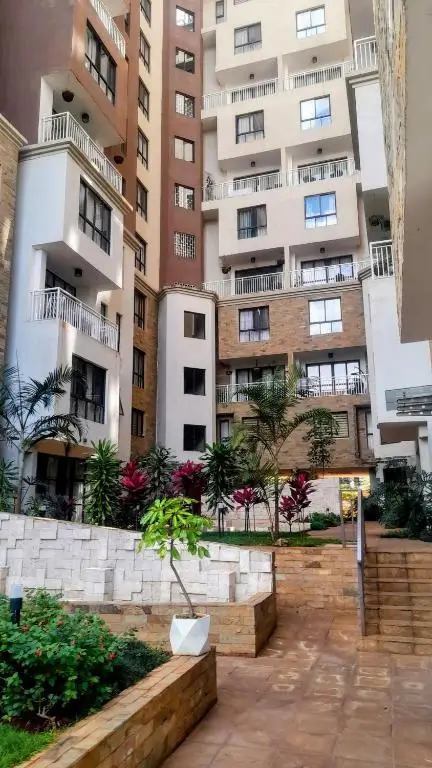 Multi-story residential compound with landscaped courtyard and planters