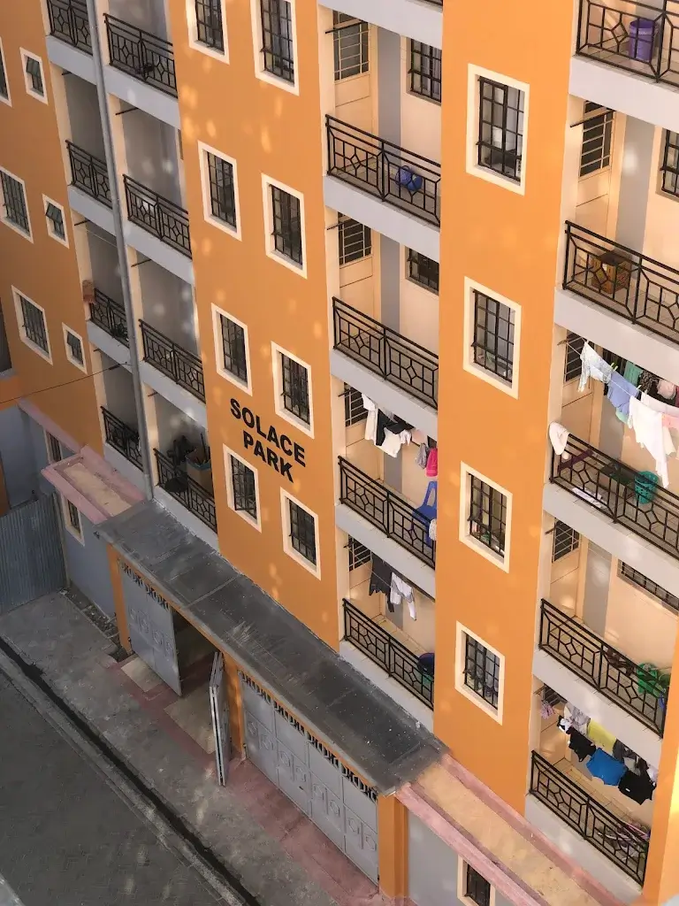 Orange apartment building facade with multiple balconies and windows
