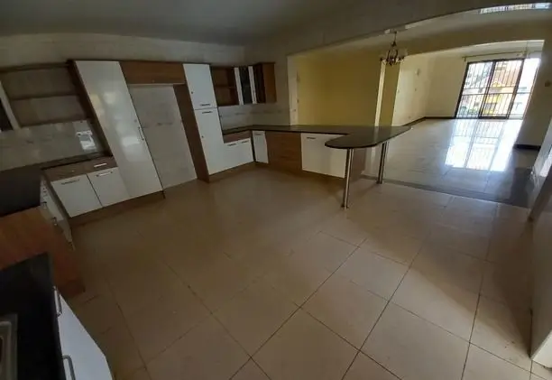 Open-plan living and kitchen space with tiled flooring
