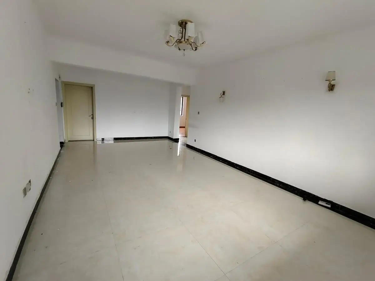 Spacious empty living room with polished concrete flooring