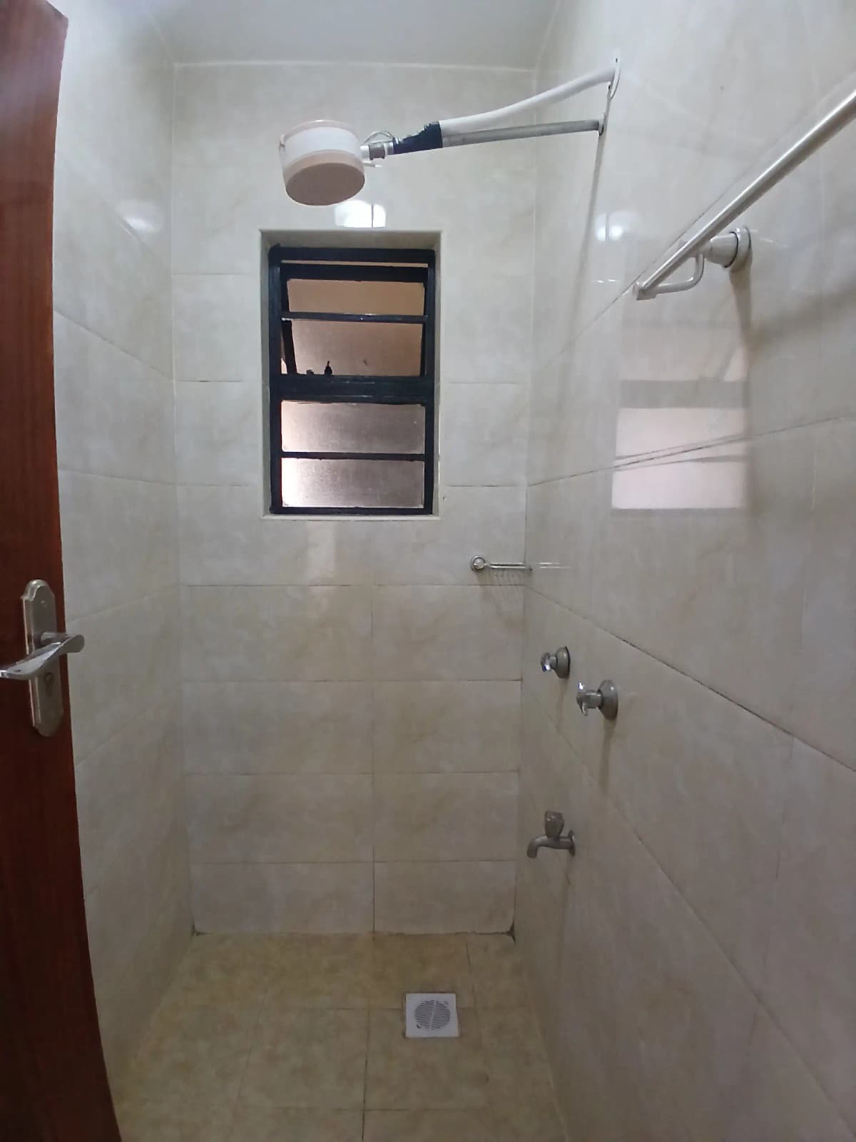 Modern shower enclosure with built-in niche and rainfall showerhead