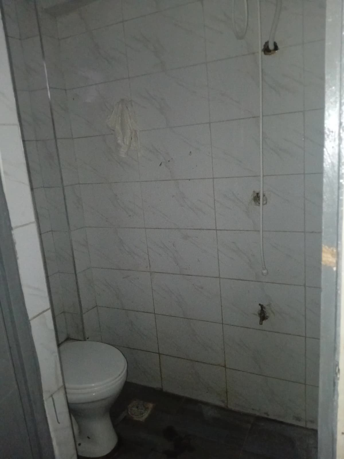 Small bathroom with toilet and tiled shower enclosure
