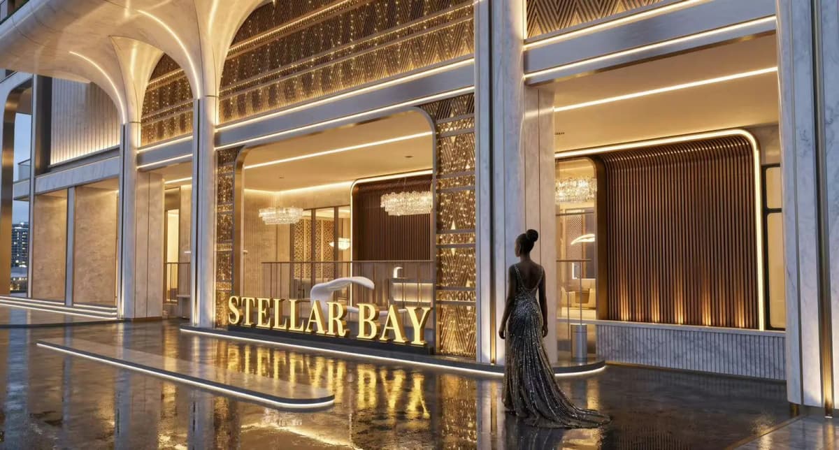 Luxury Stellar Bay building entrance with gold signage at dusk