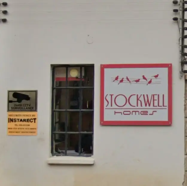 Building facade with Stockwell Homes signage and window