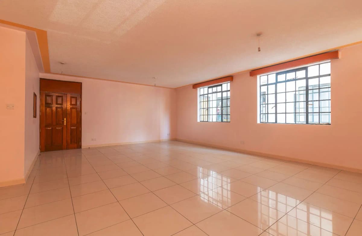 Spacious living room with polished tile floor and natural light