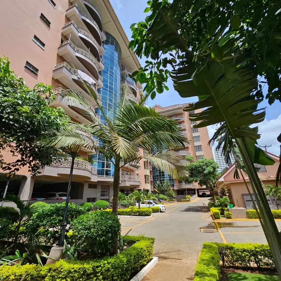 Modern residential building with manicured compound and tropical landscaping