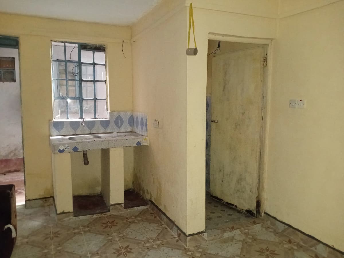Basic kitchen with window, counter space, and tile flooring