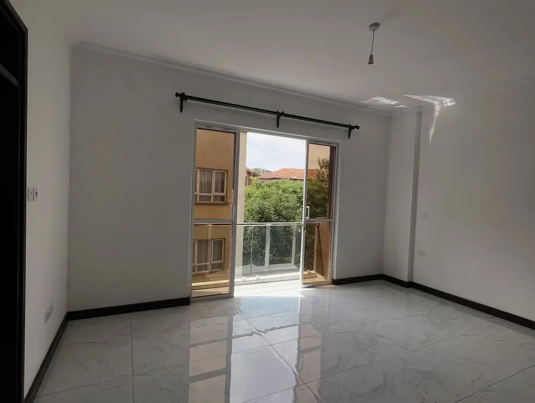 Bright living room with glass doors opening to garden view