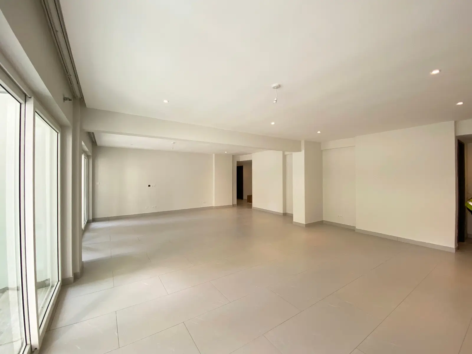 Spacious open-plan living area with floor-to-ceiling windows