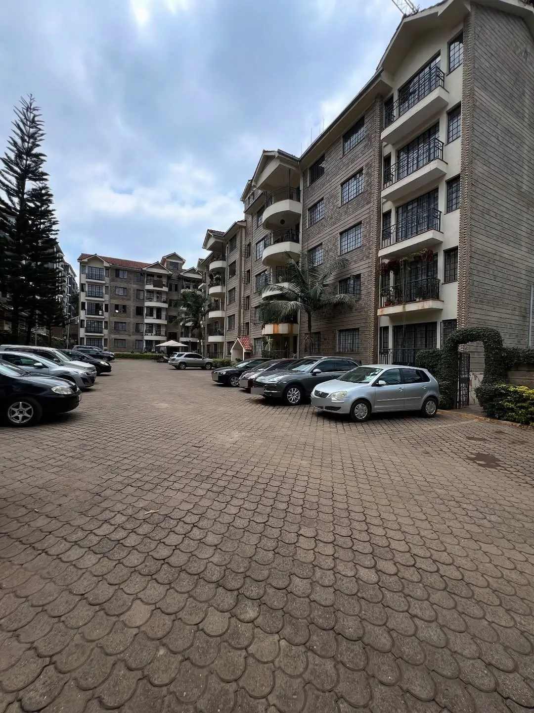 Multi-story residential complex with paved parking lot