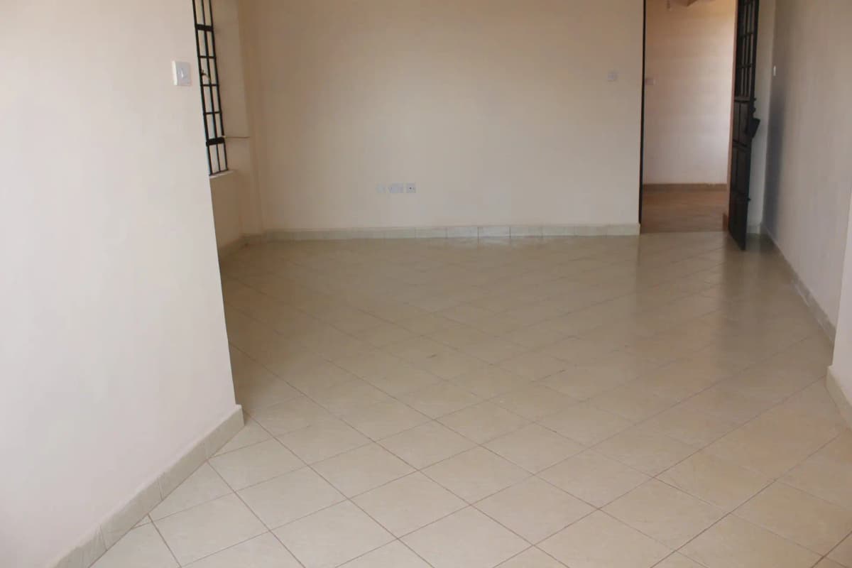 Empty living space with polished ceramic tile flooring