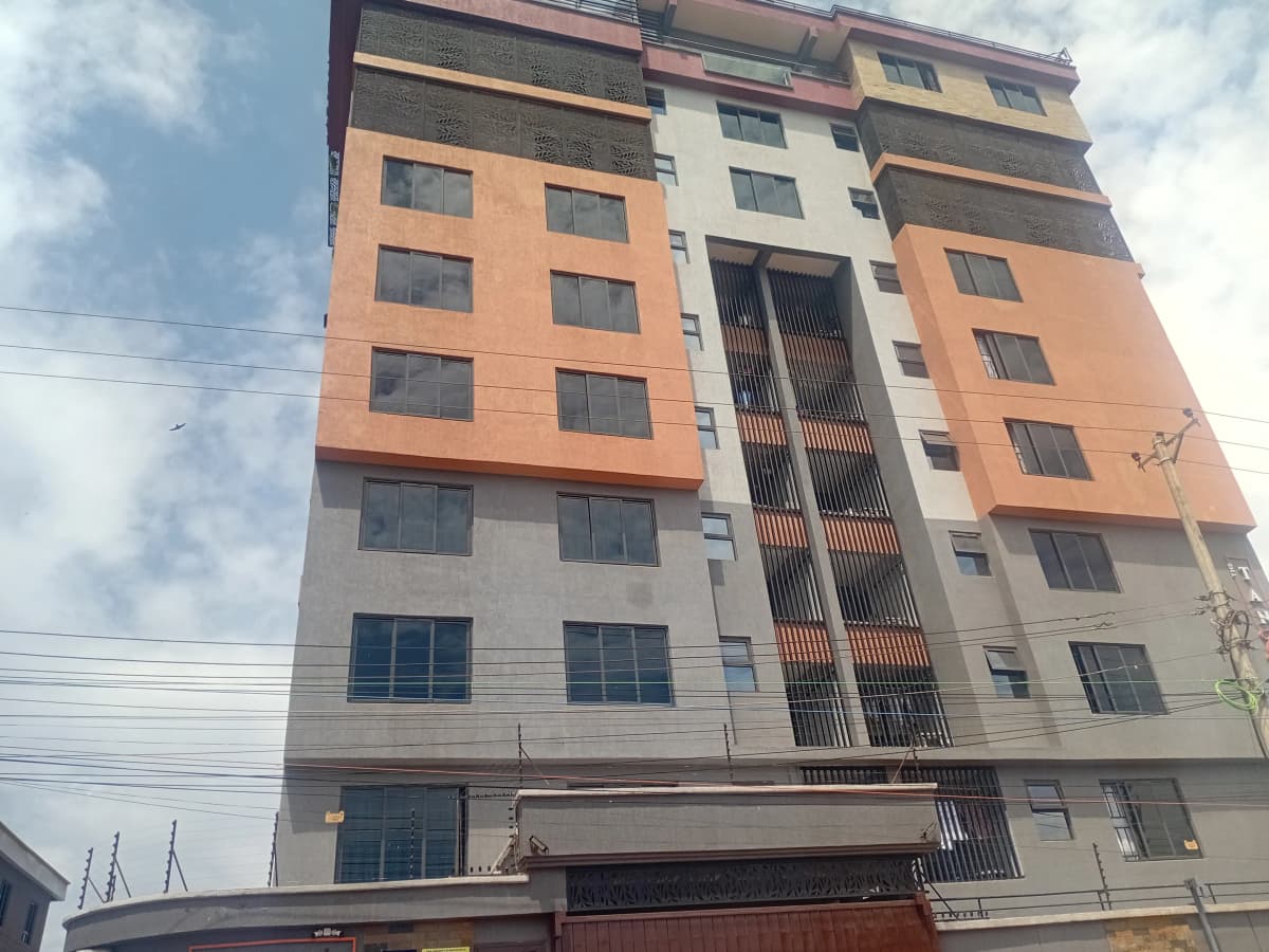 Multi-story residential building with orange and gray facade