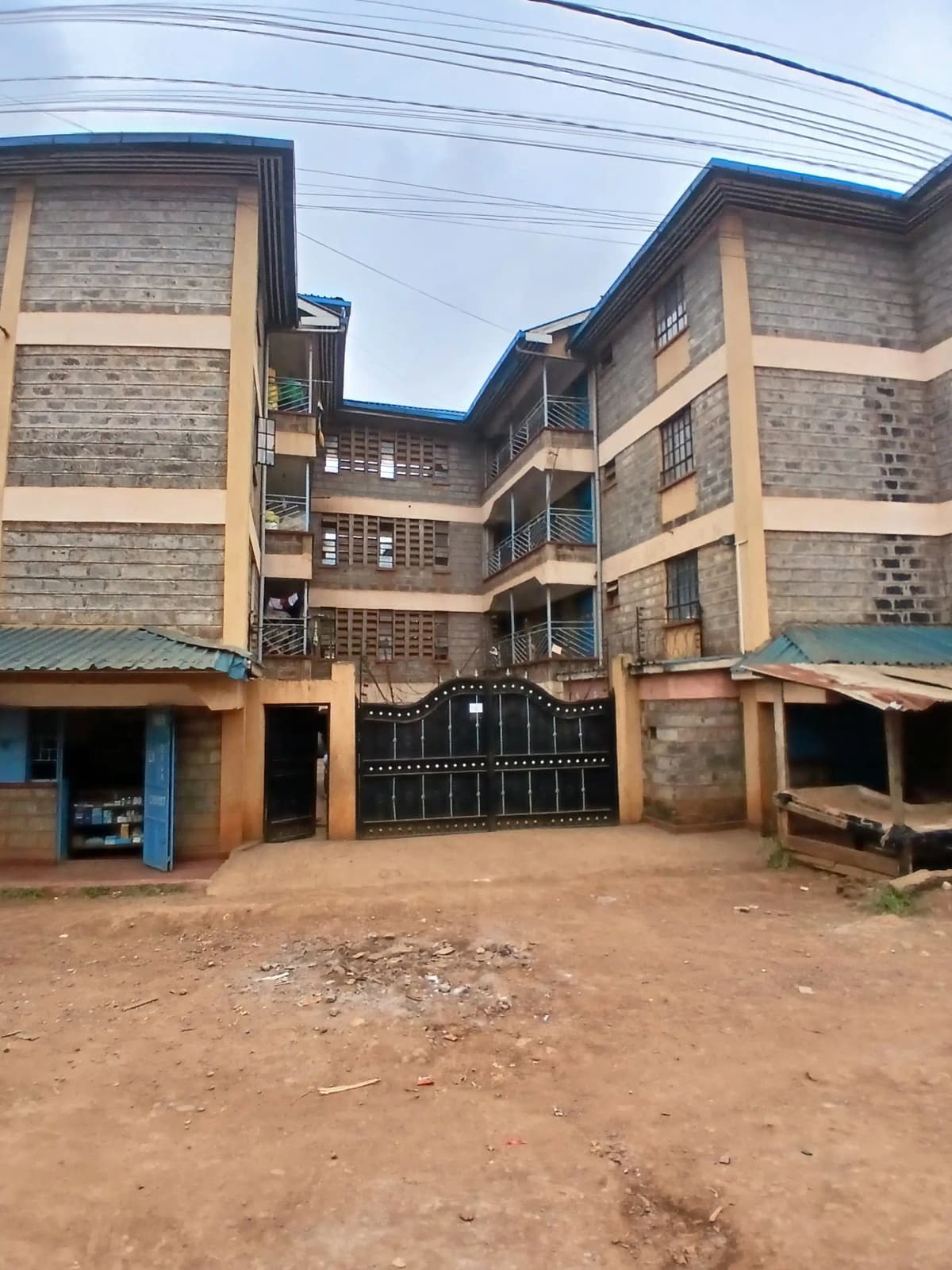 Multi-story residential building with central courtyard and ground-level entrance