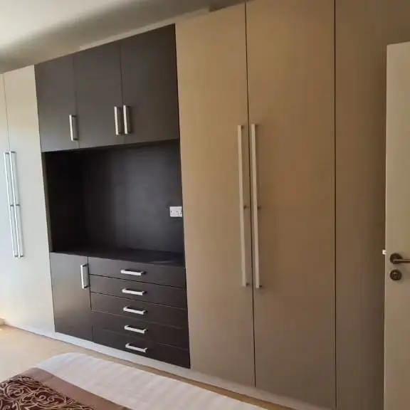 Bedroom with built-in wardrobe and entertainment unit