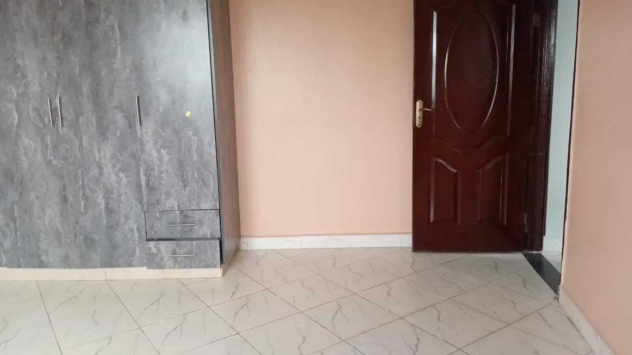Entry hallway with tiled flooring and burgundy entrance door