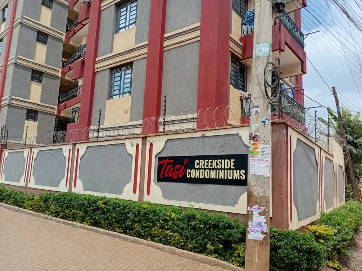Multi-story residential building with red and cream facade
