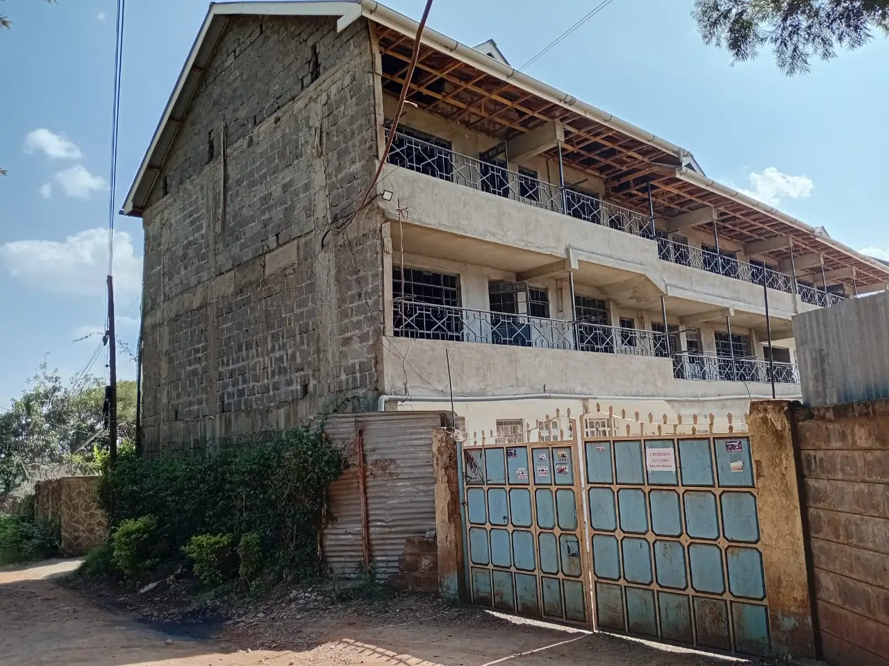 Multi-story residential building facade with metal gate entrance