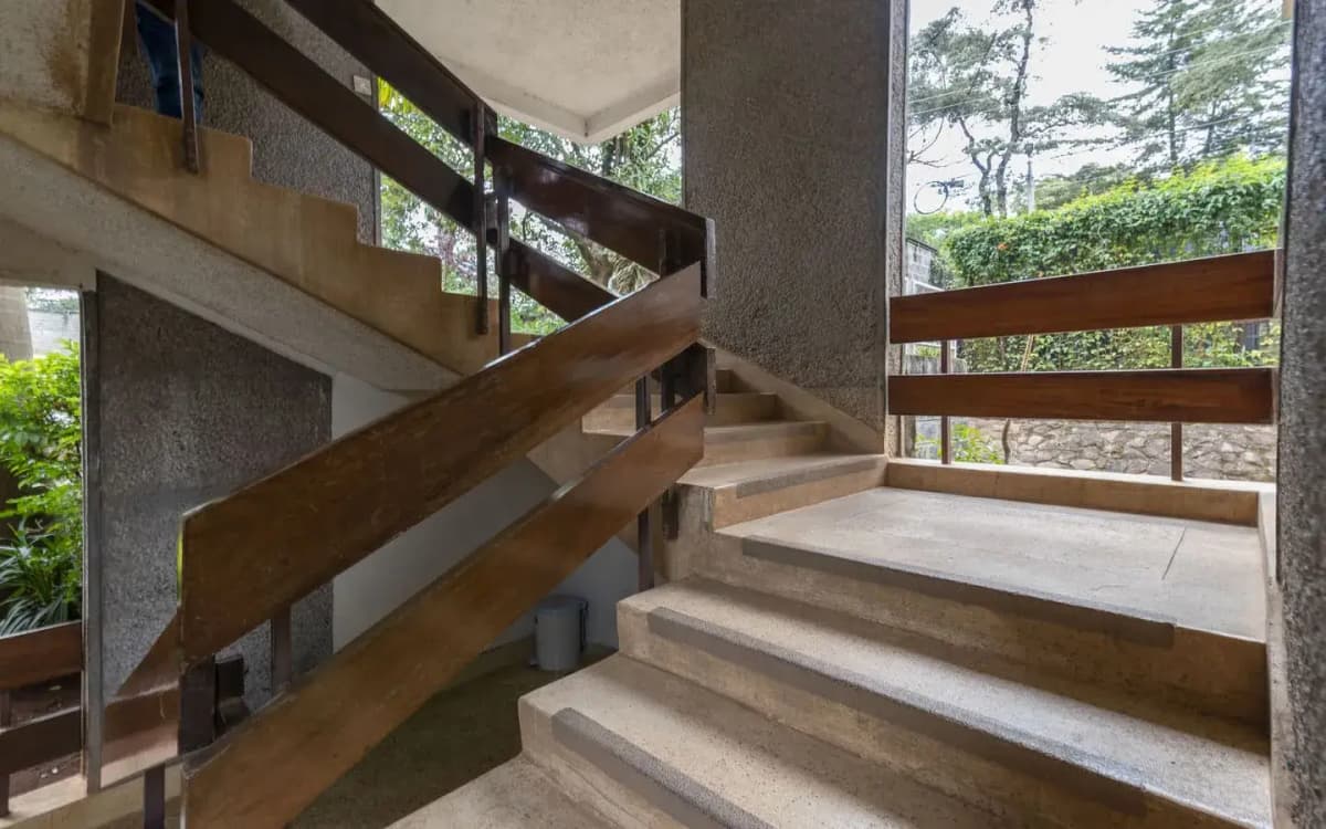 Modern staircase with wooden railings and natural light